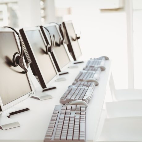 Call center computers and headsets all in a row